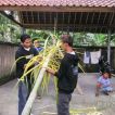 Balinese family builds a penjor