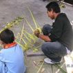 Balinese family builds a penjor